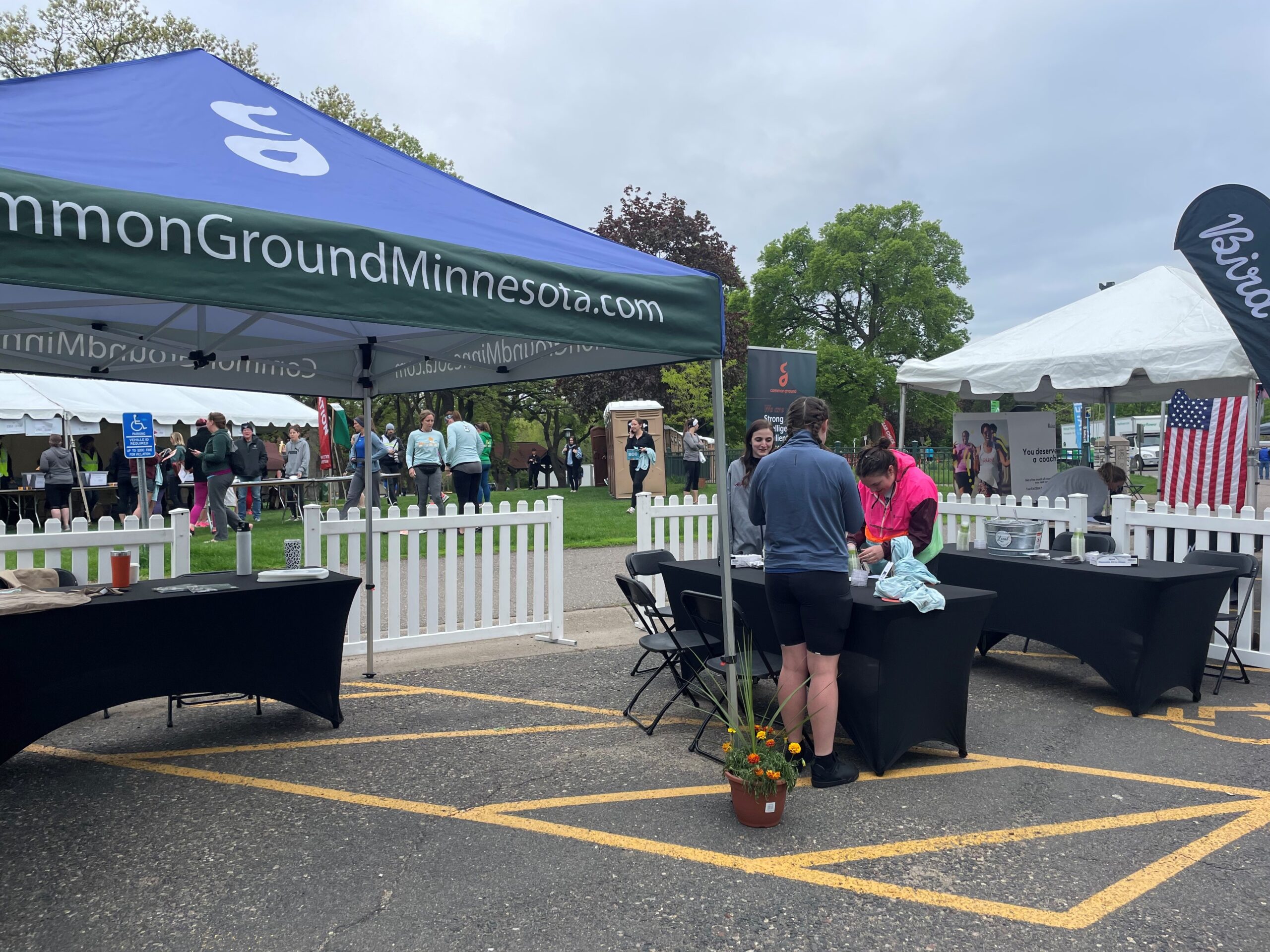 A commonground tent stands in the parking lot of an event.