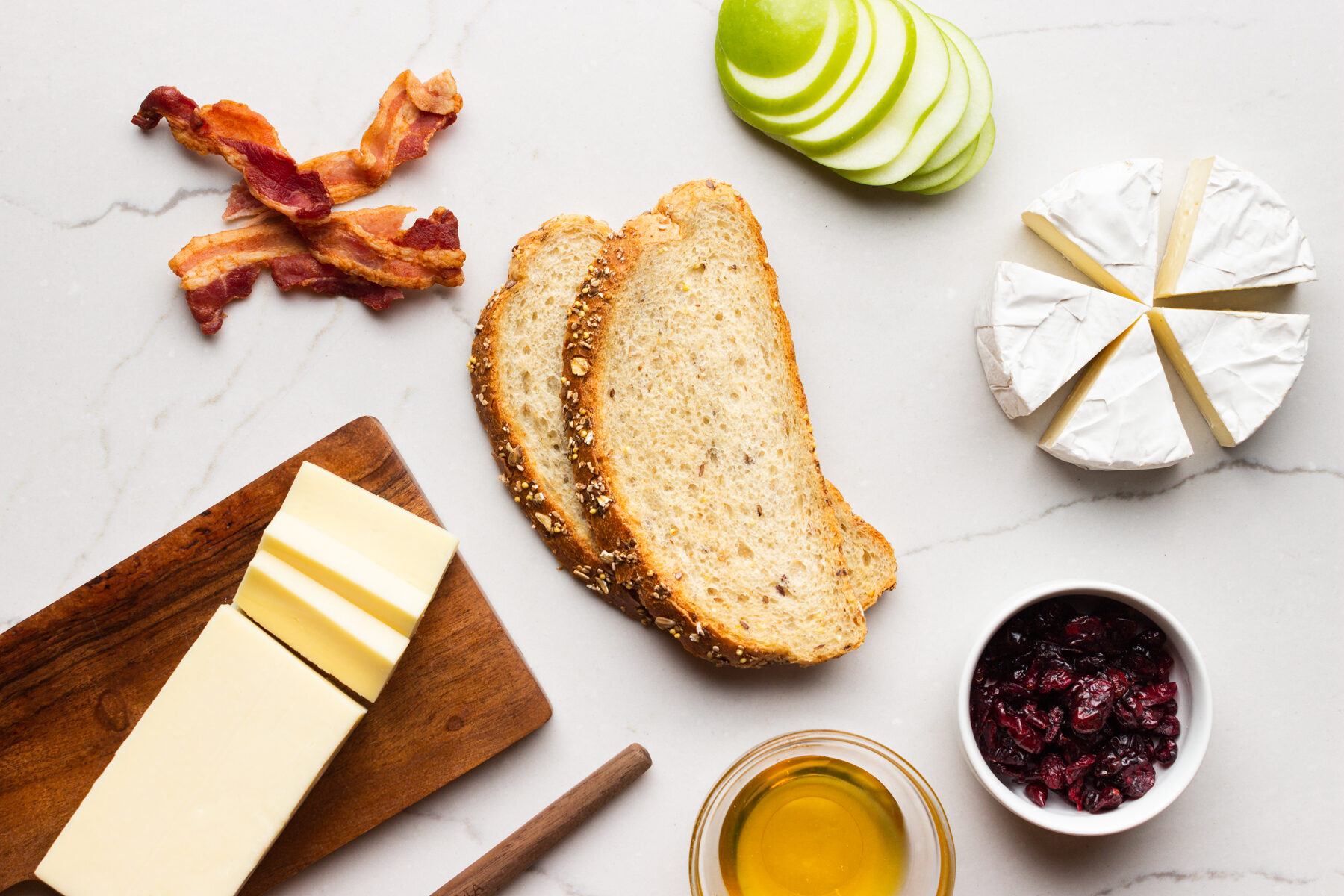 Grilled cheese ingredients on a white counter.